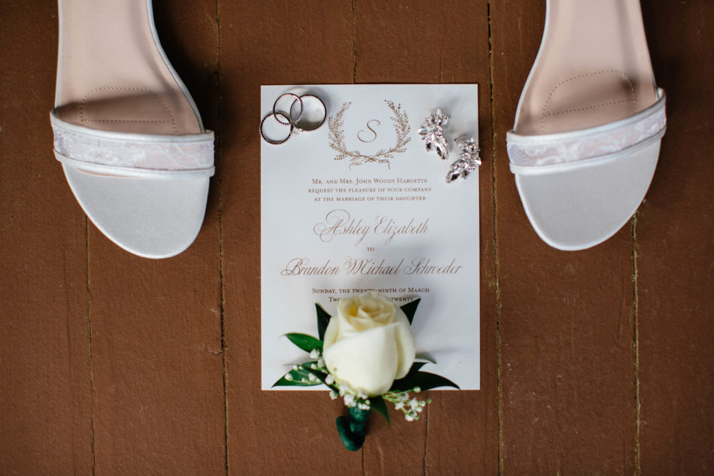 Wedding rings, invitation and shoes