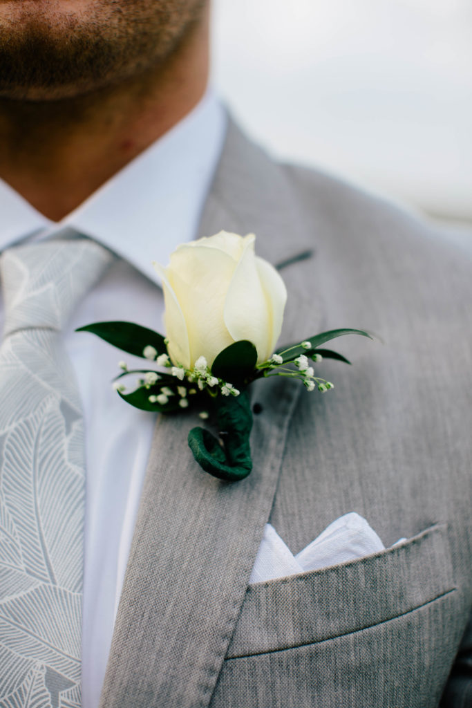 Groom's boutonnière with grey suit