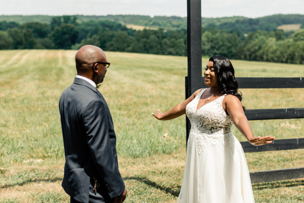 Bride, in white lace dress, seeing her dad for the first time at Carolina Country weddings venue in Charlotte.