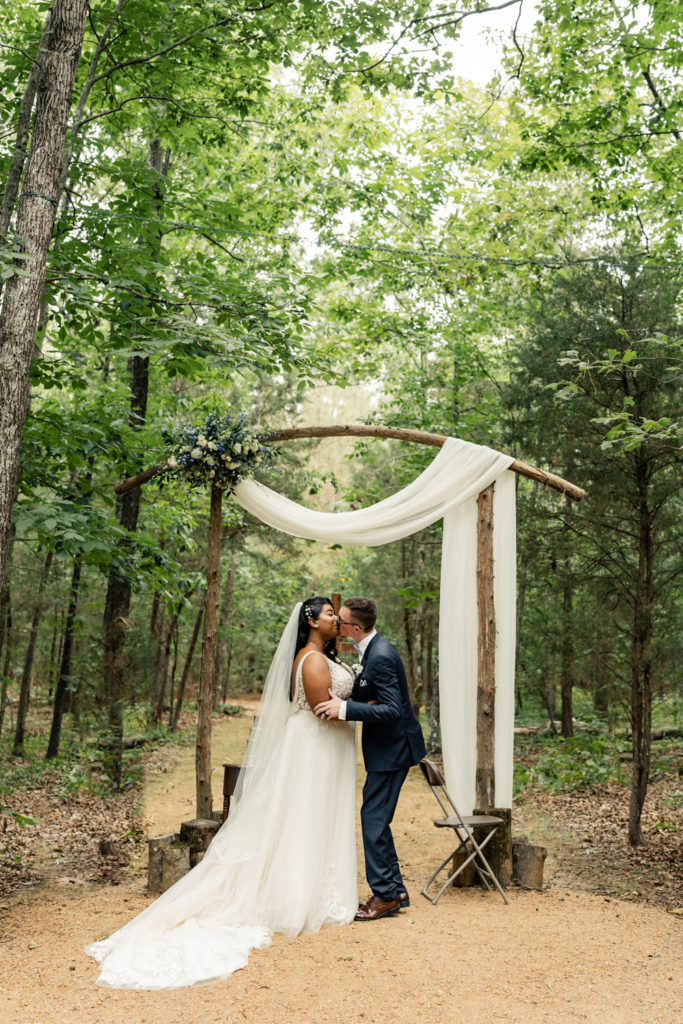 Bride and groom first kiss during ceremony at Carolina Country weddings venue in Charlotte.