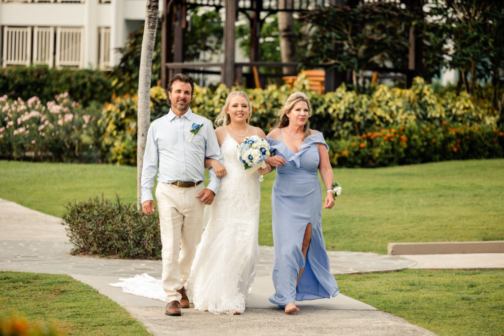 Bride walks down beach wedding aisle at the St. Lucia Grande Sandals Resort. Photographed by Charlotte wedding photographer.