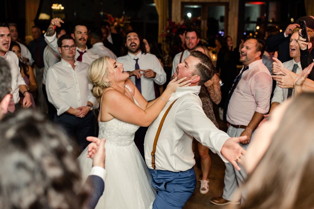 Bride and groom laughing and dancing during reception at Middleton Place wedding venue in Charleston. Photographed by Charlotte Wedding Photographer.