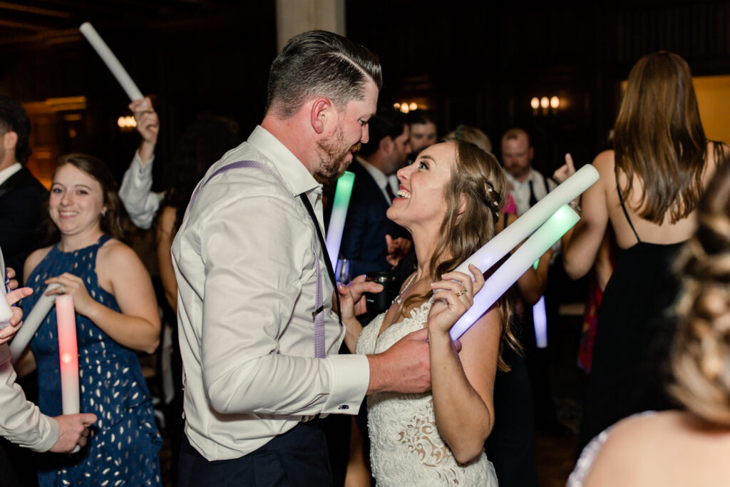 Bride and groom dancing with foam light up sticks at Long View Country Club wedding venue in Charlotte NC