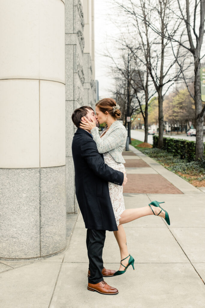 Bride and groom kiss outside of Uptown Charlotte courthouse. Photographed by Stephanie Bailey Photography. 