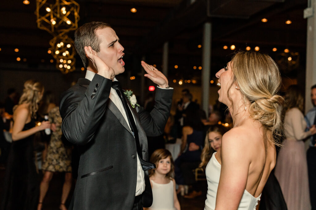Bride, in strapless white dress, dancing with groom, in black suit at Byron's South End wedding venue. Photographed by Charlotte wedding photographer, Stephanie Bailey Photography.
