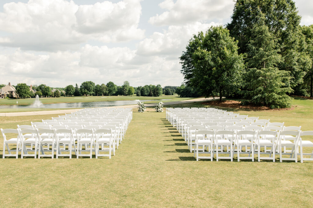 Ceremony details with white chairs and white floral arbor on the golf course of Long View Country Club Wedding Venue Charlotte NC